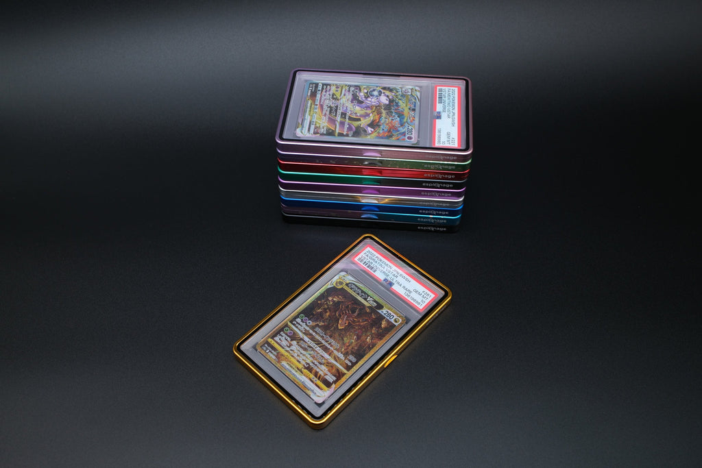 Flat lay of Espionage aluminium slab guards with graded Pokemon cards